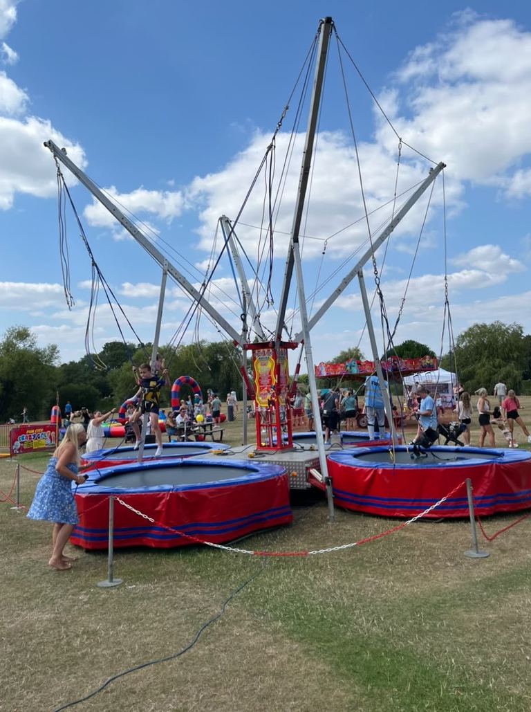 Children on a four-way bungee trampoline rig