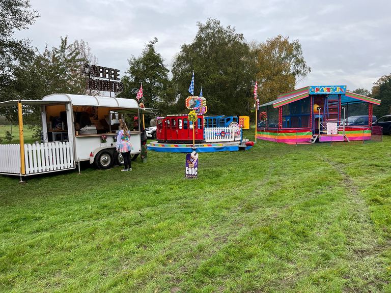 A coffee and doughnuts catering van at an outdoor event