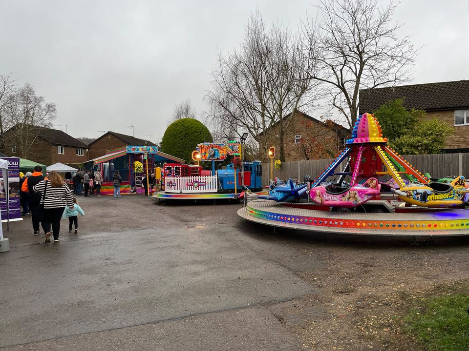 A chairoplane ride with Barbie and Minions themed cars on an overcast day