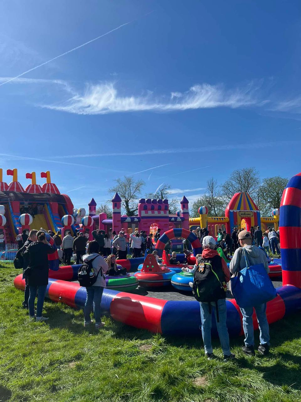 A large crowd among mega inflatables and an inflatable bumper car track