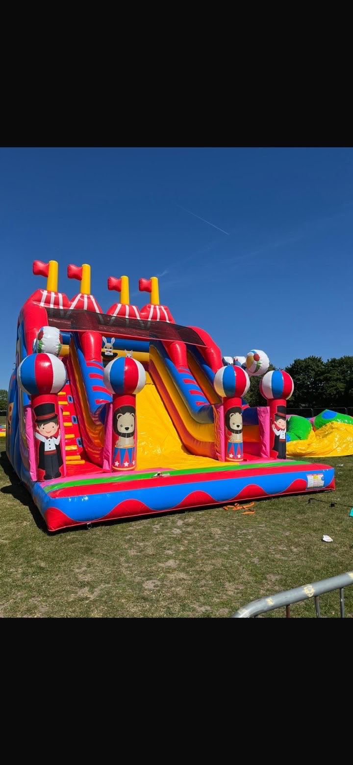 A tall circus-themed inflatable slide