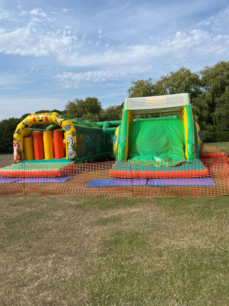 A jungle-themed inflatable obstacle course and slide