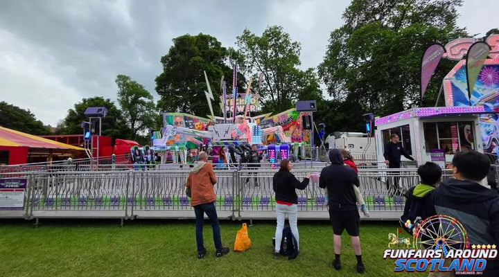 The Extreme thrill ride with riders on illuminated spinning arms