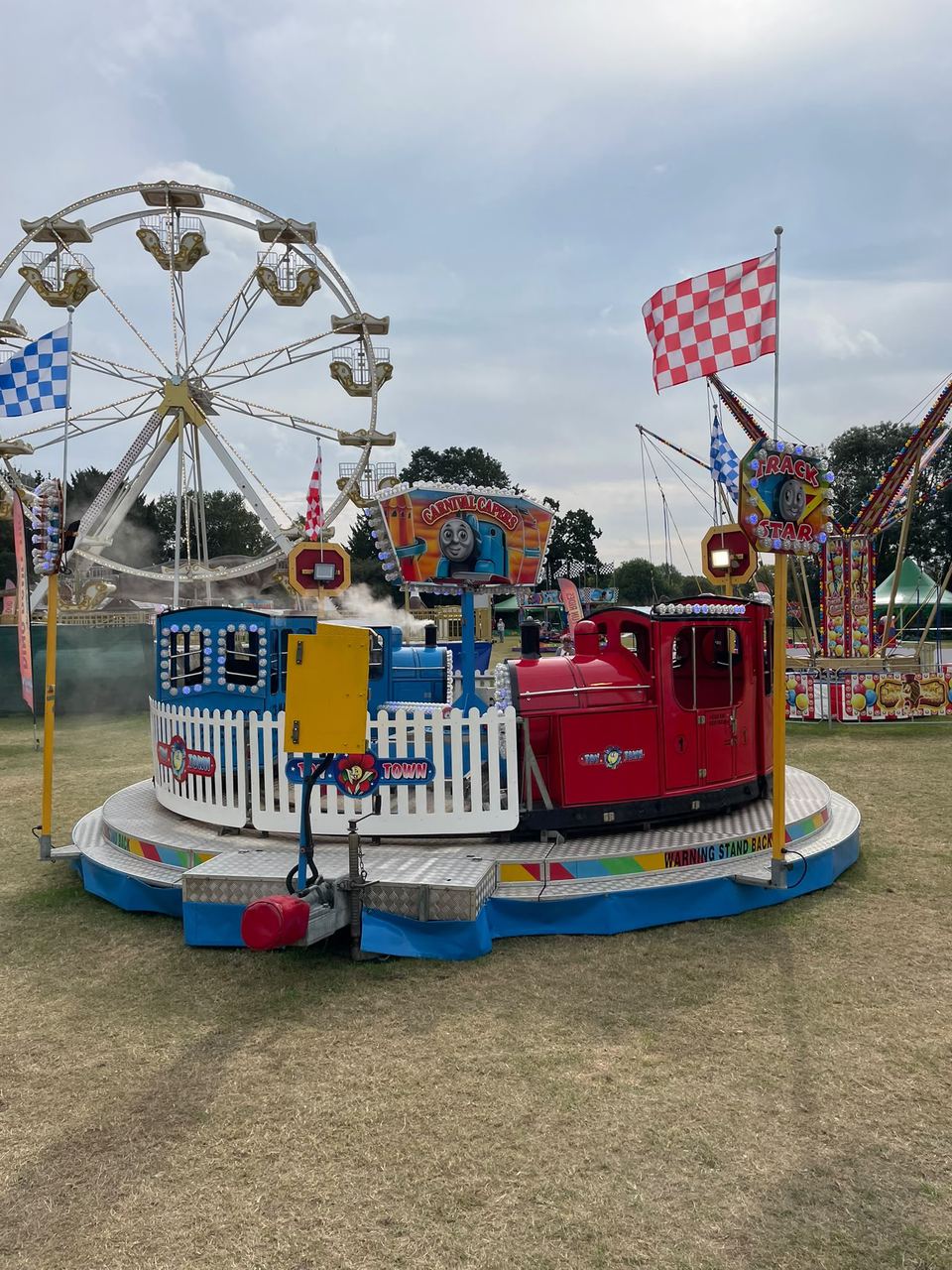 The Toy Town kids' train ride with a ferris wheel behind it